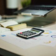 Busy work desk with a calculator.