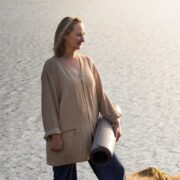 Woman standing beside a lake.