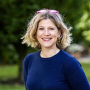 Fair-haired woman in blue jumper.