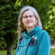 A woman wearing a green coat.