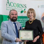 Man and woman holding a certificate.