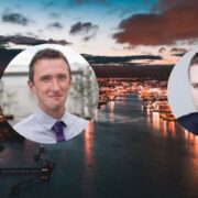 Two men inset on aerial image of Dublin city.