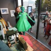 A model turns Black Friday green in a dramatic shop-window photo-call to mark the launch of Green Friday by Champion Green.
