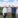 Four men in front of a wind farm.