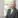 Bearded man in grey suit.