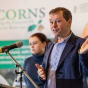 Man speaking at a microphone.