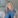 Fair-haired woman in denim shirt.