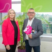 Woman in pink jacket beside man in grey jacket.