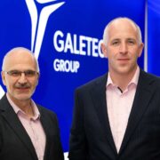 Two men in black suits.