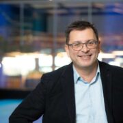 Man in black sports jacket.