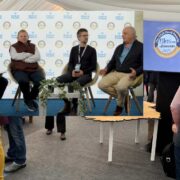 Four men inset on an image of Blas na hEireann.