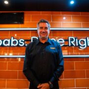 Man standing in German Doner Kebab restaurant.