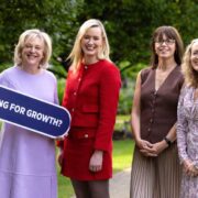 Four business women in a park.