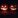 Two carved pumpkins with candles inside.