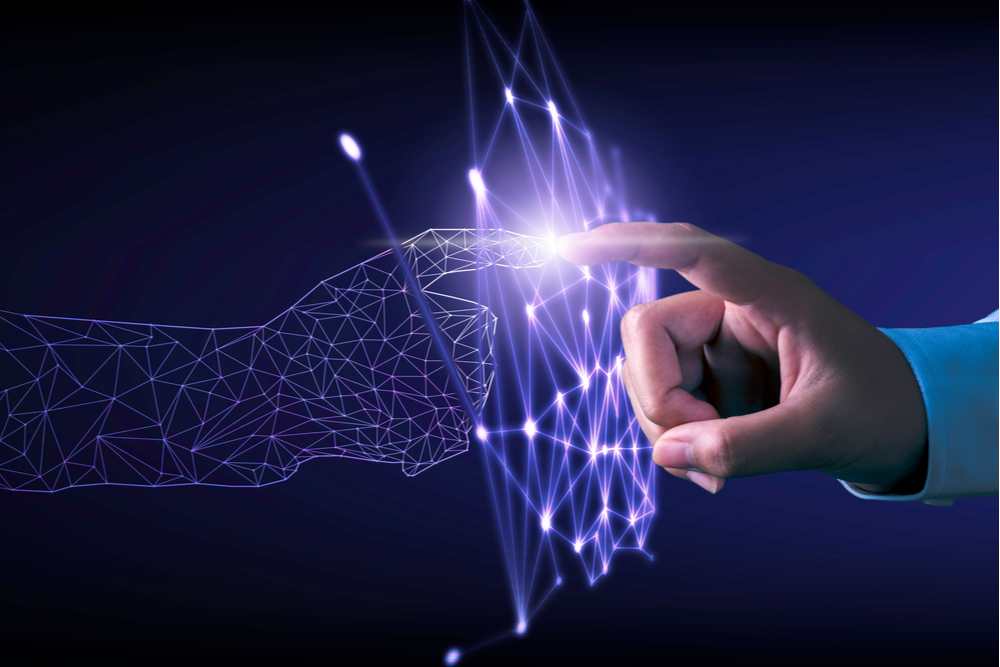 human hand touching a digital hand.