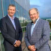 Two men in front of a building.