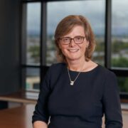 Woman sitting in boardroom.