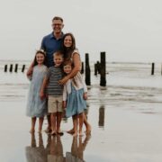 A family standing on a beach.