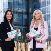 Two women standing in front of a building.