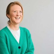 Woman wearing green cardigan.