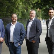 Four men standing on a street.