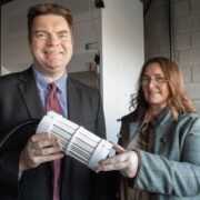 Man and woman holding a nanotech device.