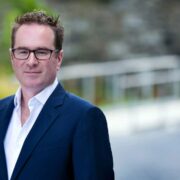 Man wearing navy sports jacket.