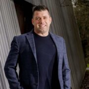 Man in navy blue sports jacket.