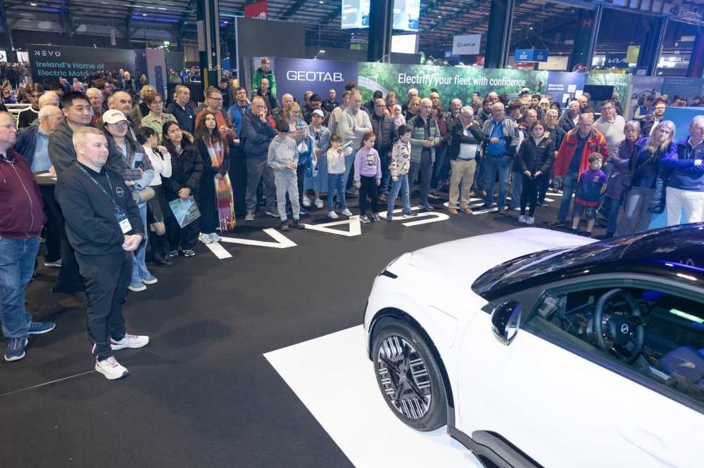 Crowd of curious consumers at an electric car show.