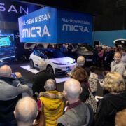People watching a car being unveiled at Nevo Electric Vehicle Show in Dublin.