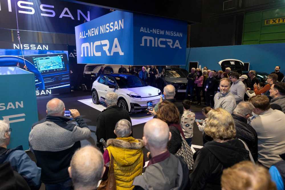 People watching a car being unveiled at Nevo Electric Vehicle Show in Dublin.