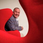 Man sitting on red chair.