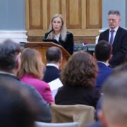 Woman speaking at a podium.