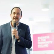 Man speaking with a microphone in his hand.