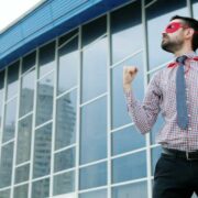Business man wearing a super hero cape.