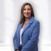 Woman wearing blue blazer.