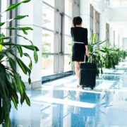 Young businesswoman talking on mobile phone in the airport.