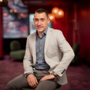 Man in beige coloured sports jacket.