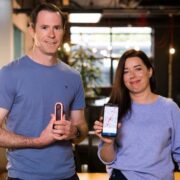 Man and woman holding AI devices.