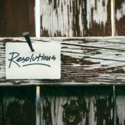 Note saying resolutions pinned to a wooden board.