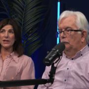 Man and woman speaking during a podcast recording.