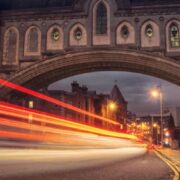 Lights blur down a street in Dublin.