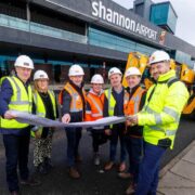 Group of men and woman in hard hats and high visibility clothing outside Shannon Airport.