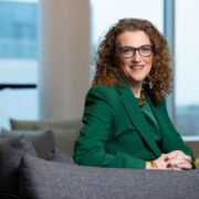 Woman wearing green jacket.