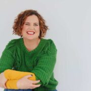 Red-haired woman in green jumper.