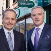 Men in suits outside a Specsavers shop.