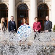 Men in women behind a fountain at Irish Government buildings.