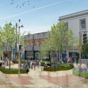 Artist&rsquo;s impression of a redesigned town centre street with widened pavements, planted trees, seating areas, cycle lanes, pedestrians crossing at traffic lights and low-rise shops and buildings lining the street.