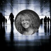 Portrait-style graphic showing a central circular headshot of a person with curly hair over a blurred, high-contrast background of silhouetted people walking through a large indoor public space with reflective flooring and overhead lights.