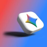 A white, rounded square 3D icon floats at a slight angle against a smooth gradient background that transitions from red on the left to blue on the right. On the face of the icon is a four-pointed, star-like shape with softly curved edges, filled with a rainbow gradient that blends red, yellow, green, and blue tones. A soft shadow appears beneath the floating icon, adding depth to the minimal, modern design.
